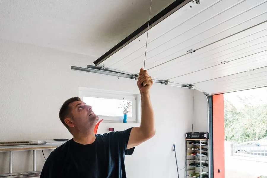 Ryan Garage Door technician adjusting a garage door